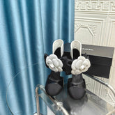 HIGH HEELS IN BLACK SHEEPSKIN WITH WHITE FLOWER